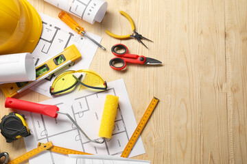 Flat lay composition with building level and other different construction tools on wooden...
