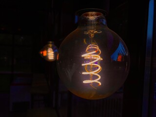 A close up of a light bulb illuminating the darkness