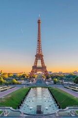 Fototapeta premium The Eiffel Tower is lit up by the sun, creating a beautiful and serene atmosphere