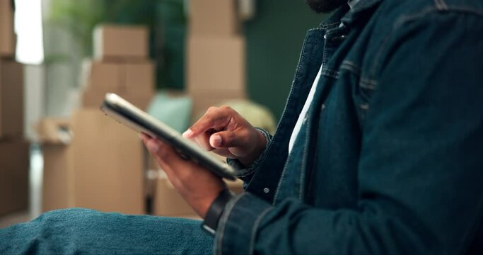 Moving, tablet and hands of man in new home with boxes for interior designing with online shopping. Cardboard, mortgage and male person with digital technology for ecommerce purchase in apartment.