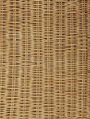 Light yellow antique vintage classic natural rattan wicker texture or background. Hard intertwined fibers of plant origin.