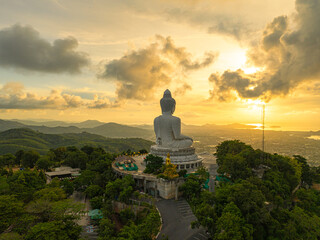 Aerial view flare of sunlight shines through the clouds above the ocean at the Big Buddha. bright...
