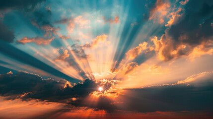 Fototapeta premium Dramatic sunset with sunlight shining through clouds in the sky