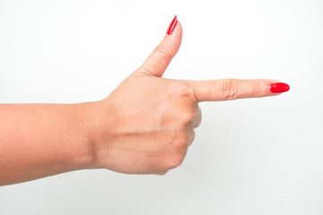 A woman's hand with bright red nail polish is pointing in a direction with her index finger and making hand gun gesture. Isolated on white background - Cut Out