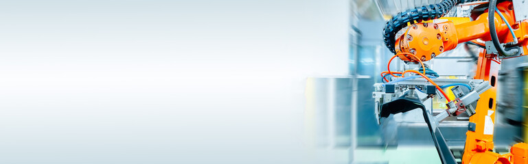 Close-up of the robot automating a mechanical process in a factory. web banner size