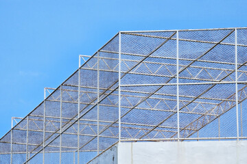 Chain Link Fence on the Rooftop of Building.