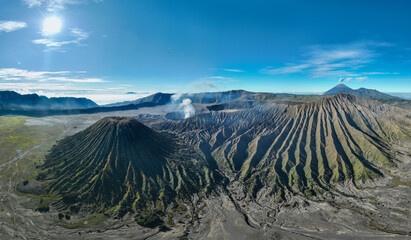 Aerial panorama view Bromo volcano constantly spews white smoke from its crater..The Bromo...