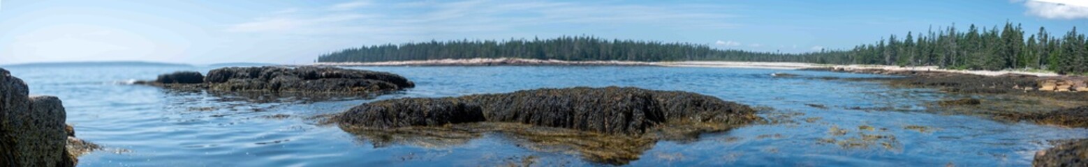 Panoramic low level view across tide pools at the oceanfront of Wonderland Trail Acadia National Park