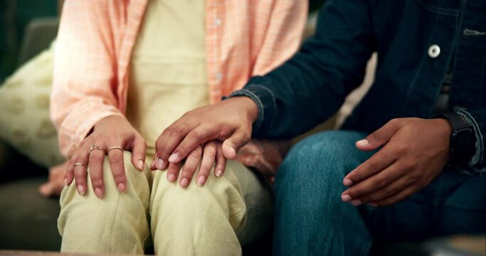 Anxiety, love and couple holding hands in support, empathy or comfort for nervous feeling on home sofa. Mental health, stress or scared person with partner care, trust and waiting for news or sorry