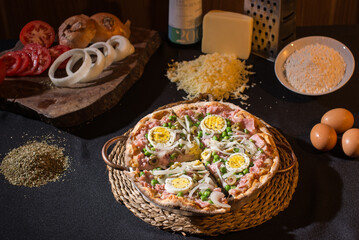 Delicious cheese pizza with onion and boiled egg being served on the stone on the table