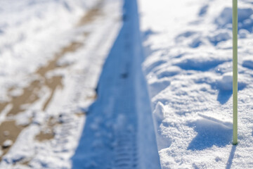 Sidewalk with edge markers used for snow blowing guides