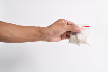 Hand holding Cocaine in plastic packet isolated on white background. illustration of illegal drug...