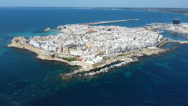 Aerial 4K footage of  Gallipoli showing the old town with it's fort, ramparts and harbor, located in Lecce province, Salento peninsula, Puglia, southern Italy