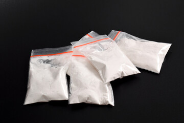 Cocaine in plastic packet isolated on black background. illustration of illegal drug substances,...