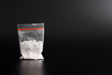Cocaine in plastic packet isolated on black background. illustration of illegal drug substances,...