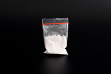 Cocaine in plastic packet isolated on black background. illustration of illegal drug substances,...