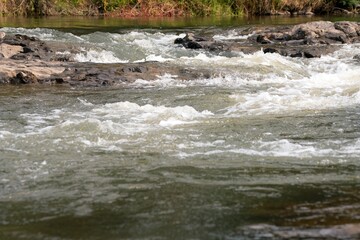 Fototapeta premium Water flows in the rocky Waitangi river 