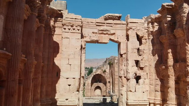 A shot of the ancient archaeological wonder Roman ruins at Baalbek, a UNESCO World Heritage site in Lebanon's Bekaa Valley. Towering columns, intricate stonework.