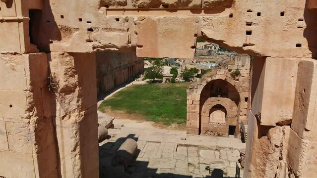 A shot of the ancient archaeological wonder Roman ruins at Baalbek, a UNESCO World Heritage site in Lebanon's Bekaa Valley. Towering columns, intricate stonework.