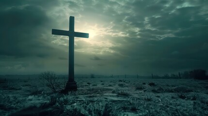 Naklejka premium An eerie, dark-toned image of a solitary cross silhouetted against a moody sky with brooding clouds and faint sunlight