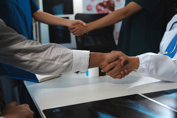 Obraz premium Doctor handshake and partnership in healthcare, medicine or trust for collaboration, unity or support.Team of medical experts shaking hands in teamwork for or success in hospital