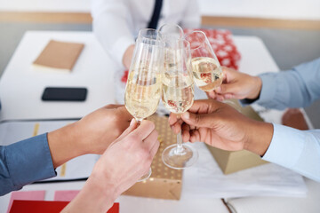 Christmas, hands and business people with toast in office with champagne and team celebration for winning award. Festive season, work break and staff party with alcohol glass for cheers together