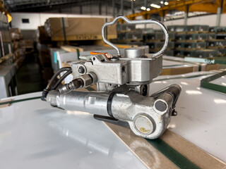 Strapping Machine | Pneumatic PET Strapping Tool for Packaging. (Soft focus)