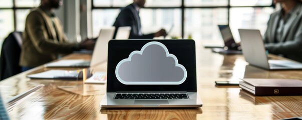 Modern Business Meeting Concept with Cloud Technology Icon Above Conference Table with Laptops, Charts, and Documents