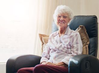 Happy, portrait and senior woman relax on a chair in nursing home with security, safety and elderly...