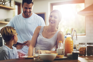 Happy family, breakfast and portrait in kitchen for nutrition, mother and healthy meal in morning. Parents, kid and smile at table for pancakes, brunch or wellness while together at home for bonding