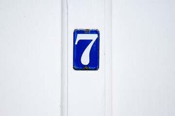 Number 7 plaque fixed to white painted door
