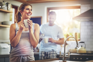 Woman, happy and thinking with coffee in kitchen for daily morning routine, peace and calm for comfort. Girl, beverage and thoughts in home with man or quiet moment, contemplation and mindfulness.