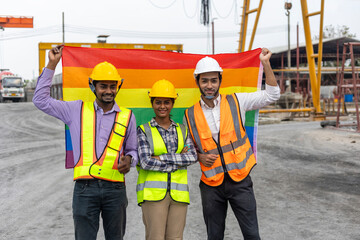 A team of factory engineers from different cultures and gender express their rights by showing flag...