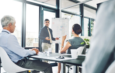 Presentation, stats or businessman by board for talking, growth or revenue graphs in meeting. Charts results, report or speaker teaching for training or sales coaching for learning in modern office