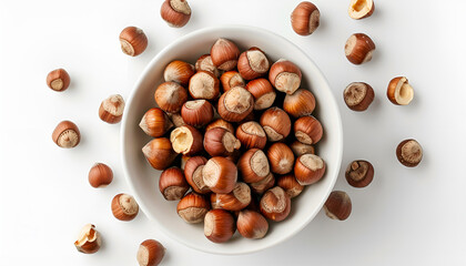 Obraz premium white bowl with raw hazelnut kernels on a white background. Bowl with tasty organic hazelnuts on white background