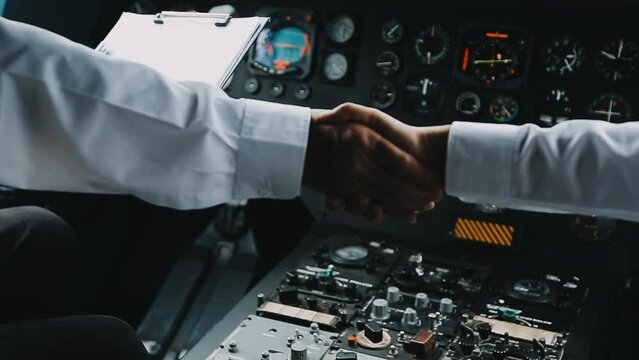 Young pilot man in uniform talking with business man about aviation businessn,startup,business team,people,Young caucasian pilot and businessman talking about Aviation business at the airport terminal
