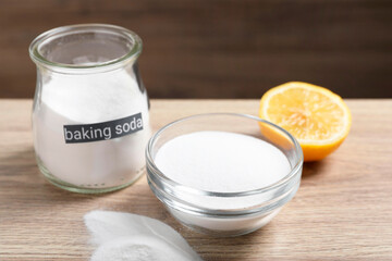 Baking soda and lemon on wooden table