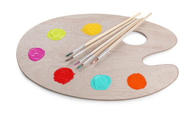 Wooden artist's palette with samples of paints and brushes isolated on white