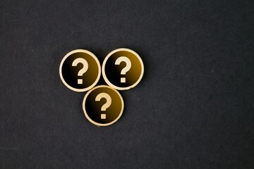 wooden round with three question marks. the concept of the question or HR