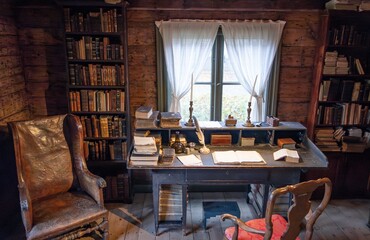 Interior of old library with vintage furniture, chair, table and books
