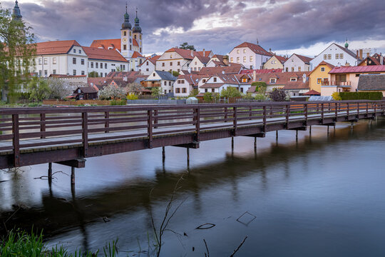 Bochemian city of Telč reflecting in the pond in the early morning, Czech Republic