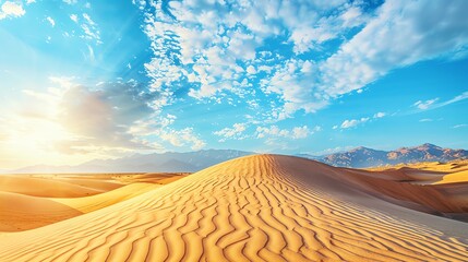 Naklejka premium A vast desert landscape with golden sand dunes under a bright blue sky with fluffy white clouds. The sun shines brightly, casting long shadows across the dunes.