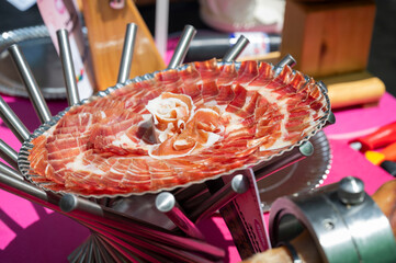 close up of a plate of Thinly Sliced Spanish iberian ham in an outdoor event