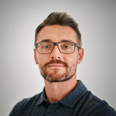 Portrait, man and confident for business in studio on white background with startup company. Headshot, mature person and satisfied with career growth and job development as entrepreneur or manager