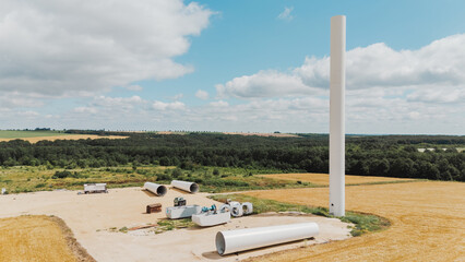 European Green Deal. Aerial Wind turbine spare parts at the construction site of a wind turbine farm © glebzter