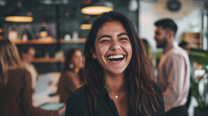Obraz premium People laughing at work. Focus on the female boss during a meeting with the team