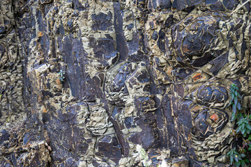 An abstract natural stone background. A banner made of stone. The rocks were artfully sculpted by a powerful volcano as early as 80 million years ago.