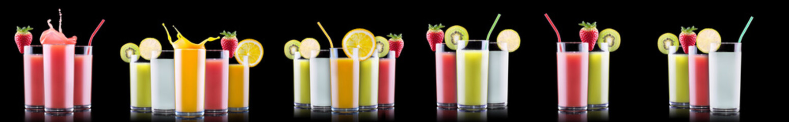 Delicious Fruit Smoothies in glass with splash isolated on a black background