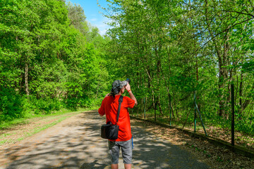 Fotograf na pieszej wycieczce robi zdjęcia drzewom  © Paweł Kacperek