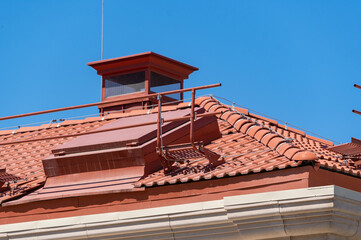 house with a roof from a red shingles with a pipe